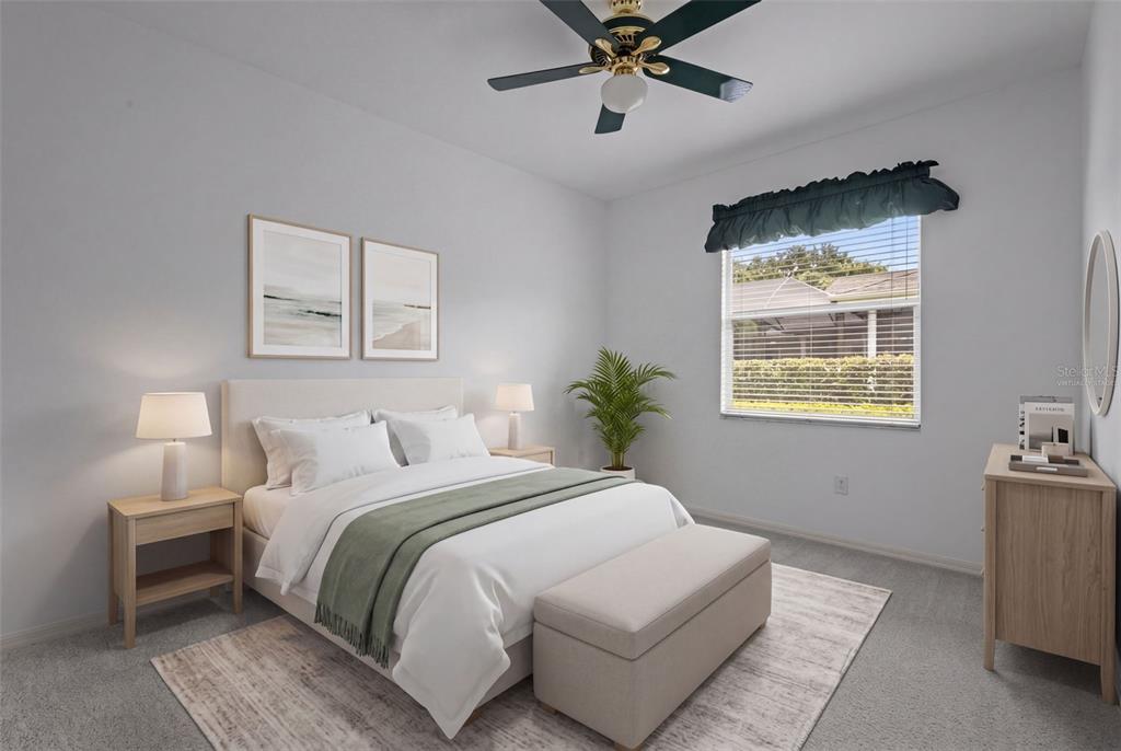 18543 Bittern Avenue Lutz, FL 33558 - Photo 14 of 45 a bedroom with a bed and a chandelier