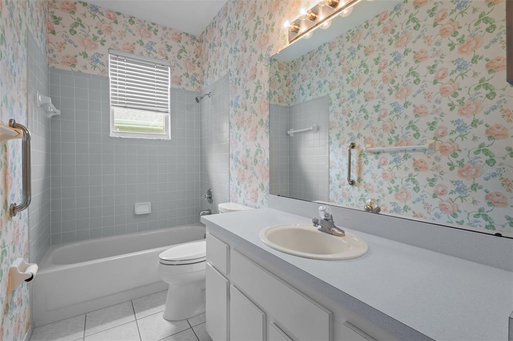 18543 Bittern Avenue Lutz, FL 33558 - Photo 15 of 45 a bathroom with a granite countertop sink toilet and shower