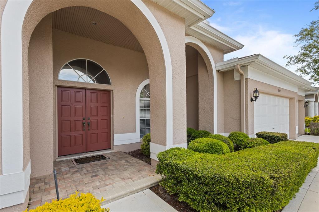 18543 Bittern Avenue Lutz, FL 33558 - Photo 27 of 45 a front view of a house with garden