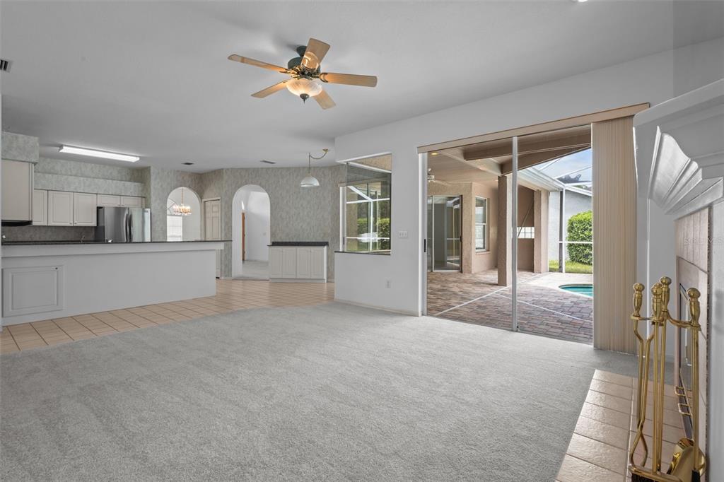 18543 Bittern Avenue Lutz, FL 33558 - Photo 31 of 45 a view of a big room with wooden floor and a kitchen