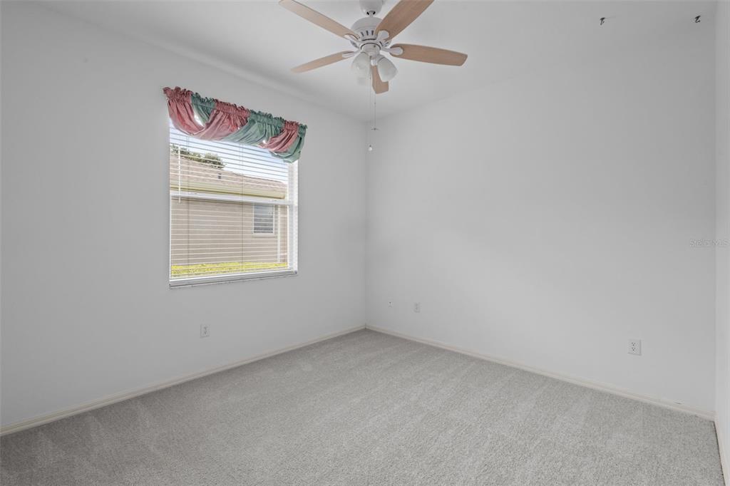 18543 Bittern Avenue Lutz, FL 33558 - Photo 37 of 45 an empty room with windows and fan