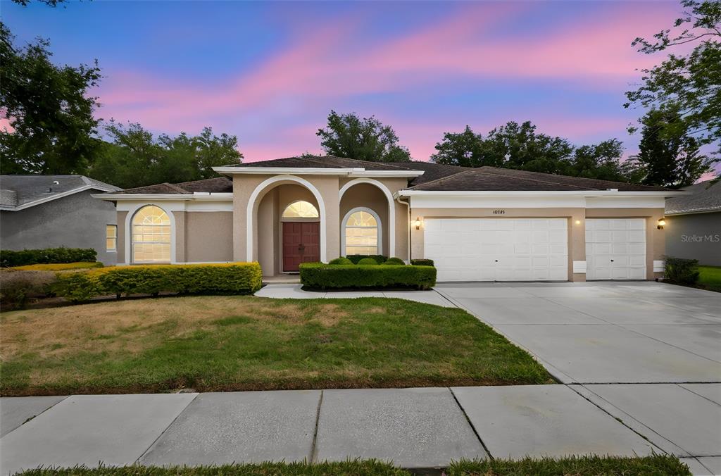 18543 Bittern Avenue Lutz, FL 33558 - Photo 43 of 45 a front view of a house with a yard