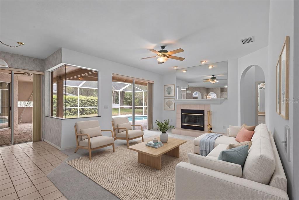 18543 Bittern Avenue Lutz, FL 33558 - Photo 5 of 45 a living room with furniture fireplace and a large window