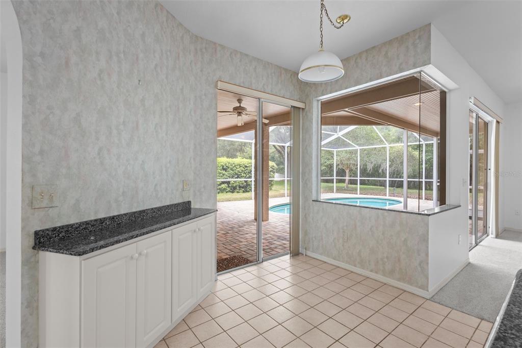 18543 Bittern Avenue Lutz, FL 33558 - Photo 7 of 45 a kitchen with granite countertop cabinets and window