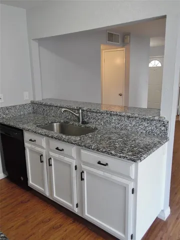 a kitchen with granite countertop white cabinets and a granite counter tops