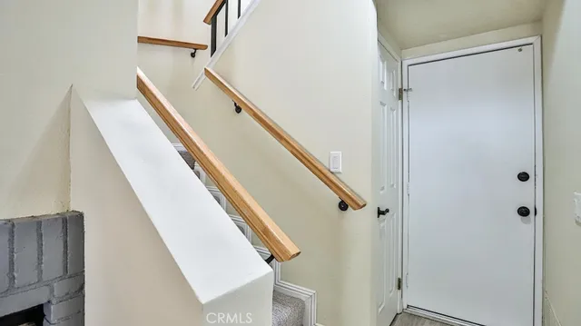 a bedroom with a bed and dresser with mirror