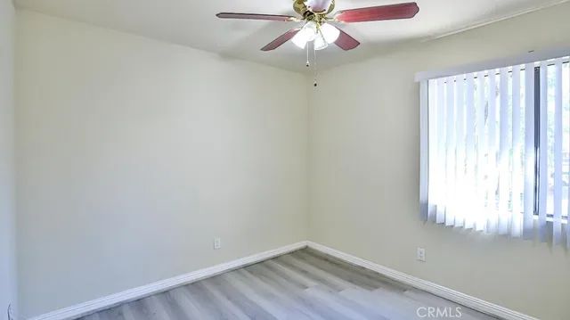 a view of a street with a house in the background