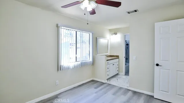 a view of backyard with swimming pool and seating space