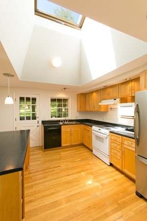 76 Sunset Road Carlisle, MA 01741 - Photo 4 of 29 a large kitchen with stainless steel appliances granite countertop a sink and a counter space