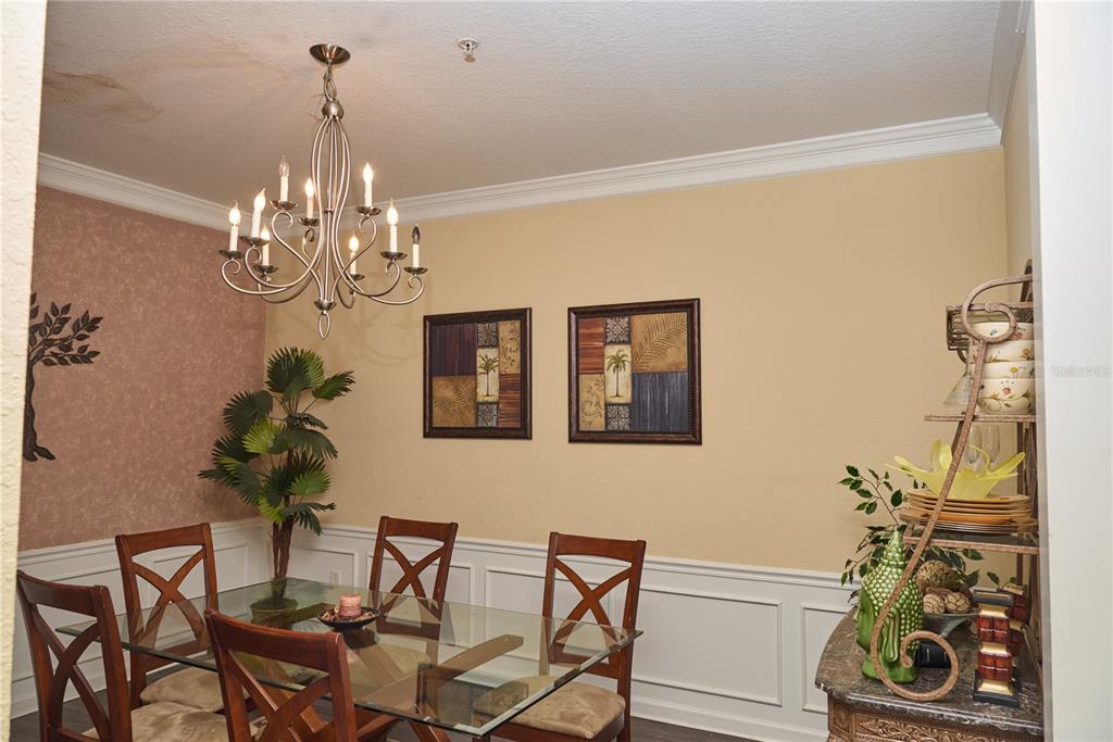 5012 Shoreway Loop, Unit 10407 Orlando, FL 32819 - Photo 14 of 35 a view of a dining room with furniture and chandelier