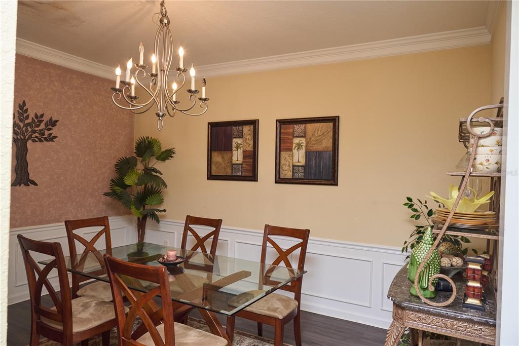 5012 Shoreway Loop, Unit 10407 Orlando, FL 32819 - Photo 15 of 35 a view of a dining room with furniture and chandelier