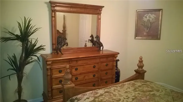 a room with a bed and a potted plant