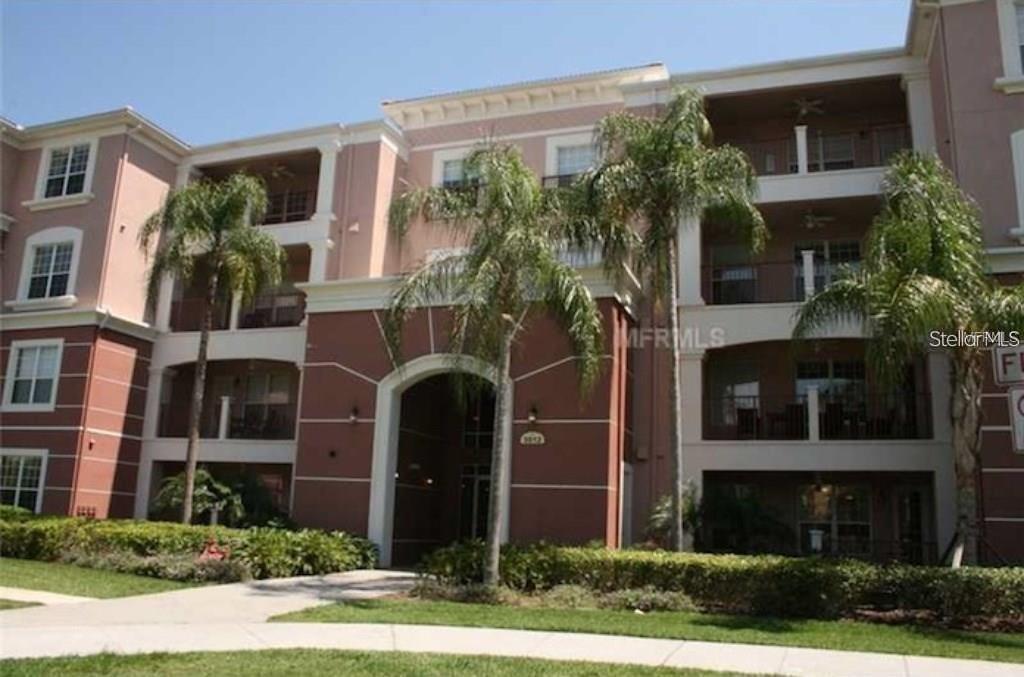 5012 Shoreway Loop, Unit 10407 Orlando, FL 32819 - Photo 3 of 35 a front view of a house with yard