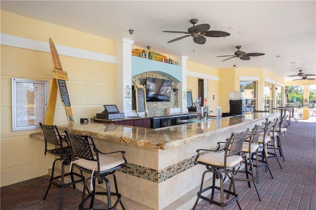 5012 Shoreway Loop, Unit 10407 Orlando, FL 32819 - Photo 32 of 35 a view of a dining room with furniture window and wooden floor
