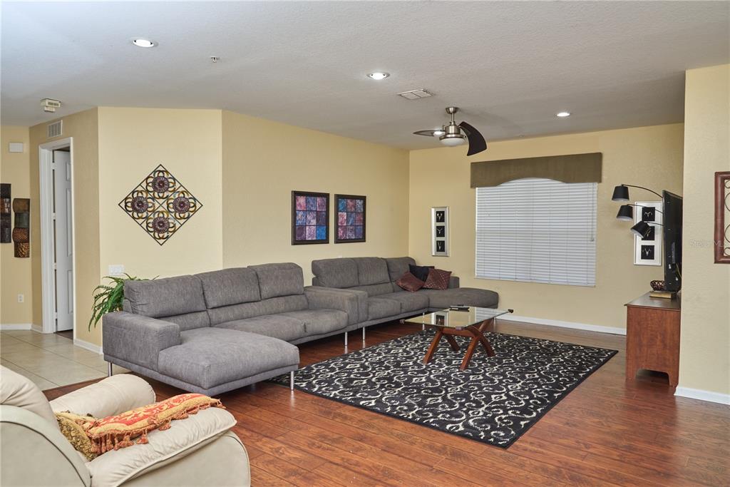 5012 Shoreway Loop, Unit 10407 Orlando, FL 32819 - Photo 6 of 35 a living room with furniture and a rug