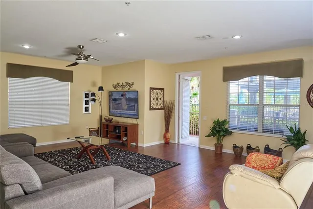 a living room with furniture and wooden floor