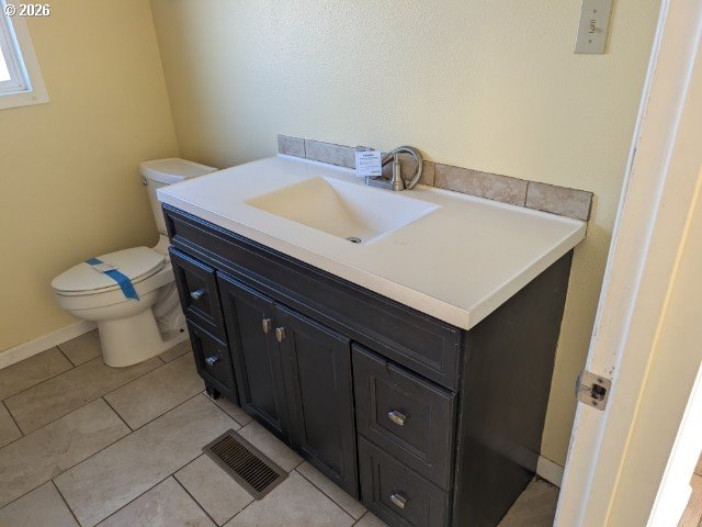 1380 Detroit Street Elgin, OR 97827 - Photo 17 of 28 a bathroom with a sink toilet and vanity