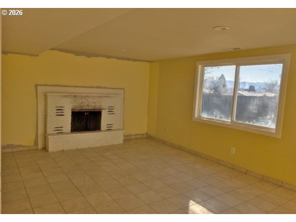 1380 Detroit Street Elgin, OR 97827 - Photo 24 of 28 a view of an empty room with a fireplace and a window