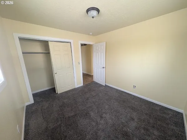 an empty room with a empty space and windows