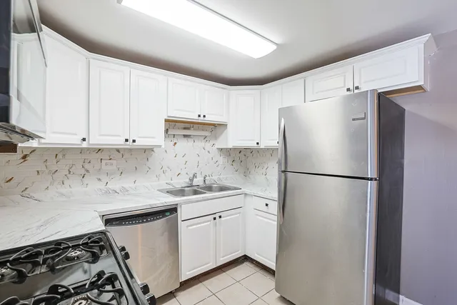 a white refrigerator freezer sitting inside of a kitchen