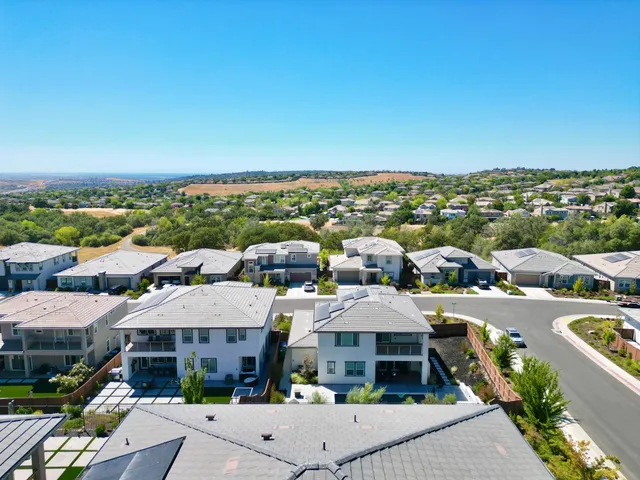 a kitchen with kitchen island granite countertop a sink and refrigerator