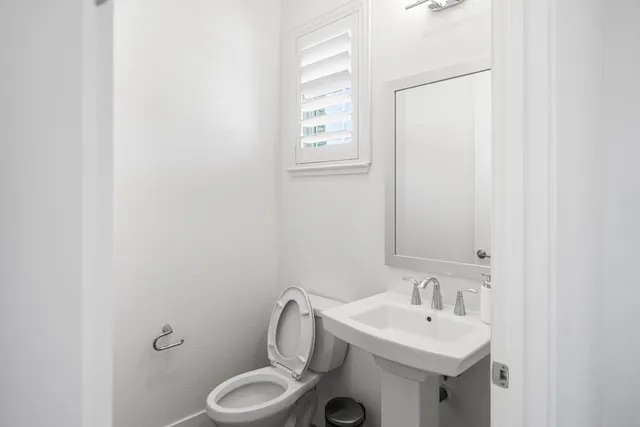 a living room with furniture and a table with wooden floor