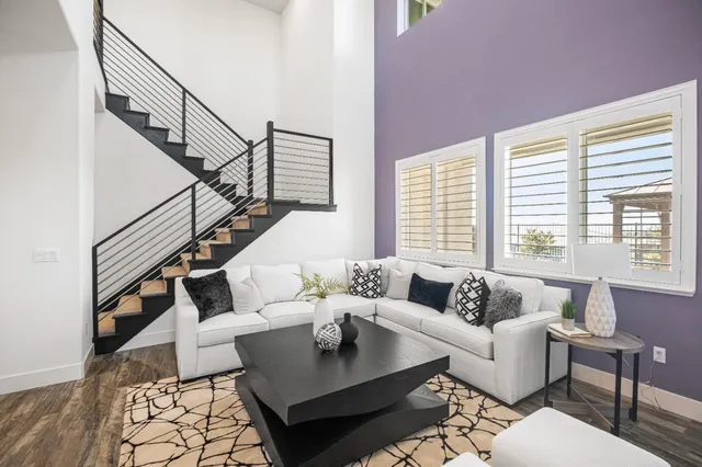 a spacious bedroom with a bed and a potted plant