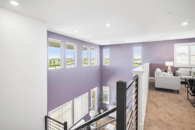 a view of a hallway with wooden floor and entryway