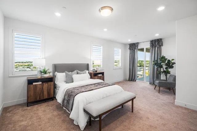 a view of a hallway with a livingroom and a bathroom with a sink