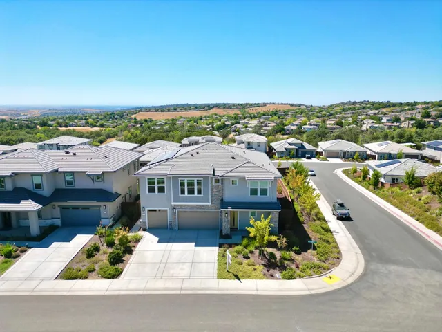 an aerial view of a house with a yard