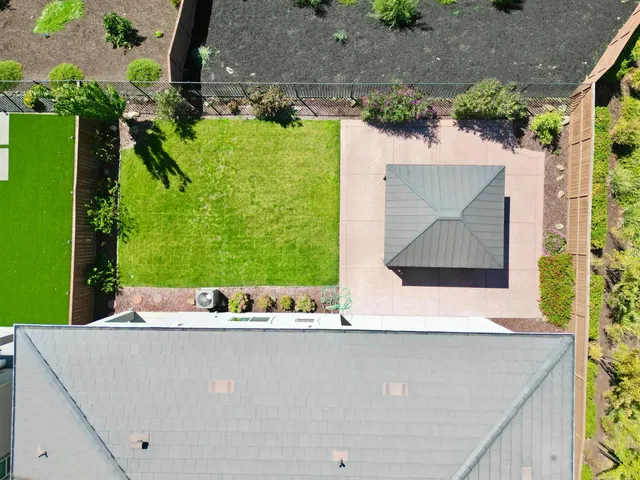 an aerial view of a city with lots of residential buildings and ocean view in back