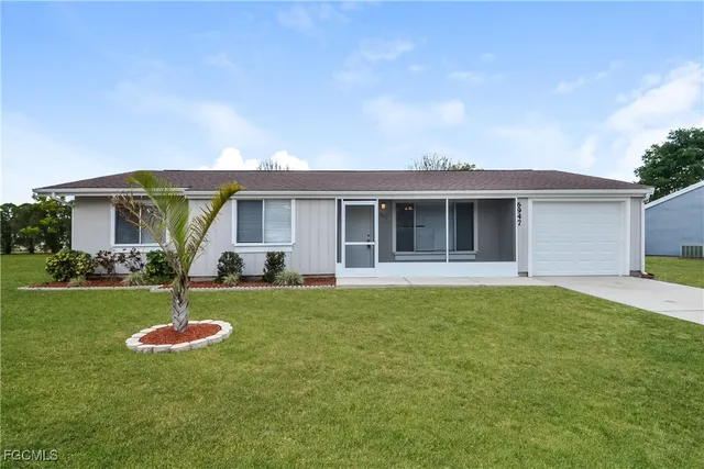 a backyard of a house with table and chairs