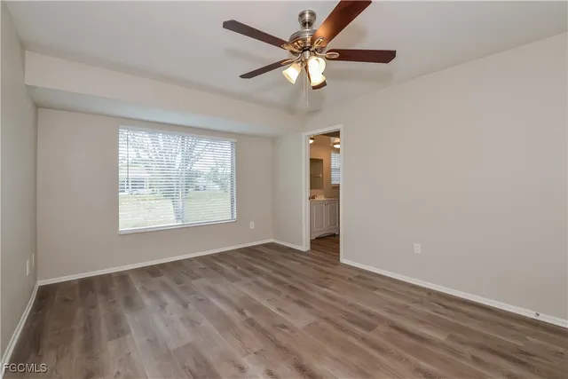 wooden floor in an empty room with a window