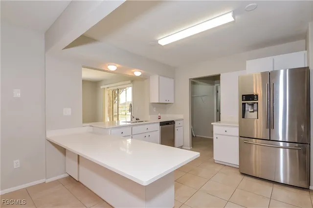a kitchen with stainless steel appliances a refrigerator sink and stove