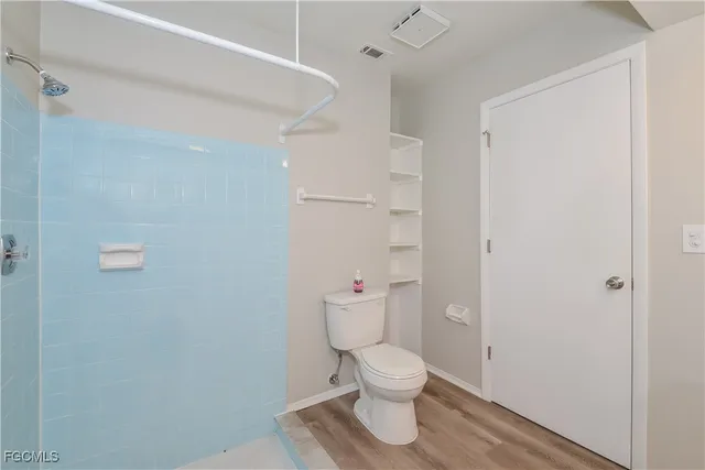 a white toilet sitting next to a bathroom sink