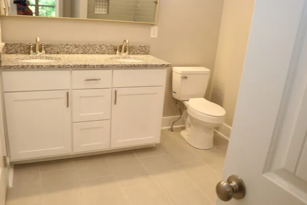 a bathroom with a sink toilet and vanity