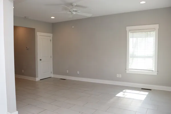 an empty room with windows and closet