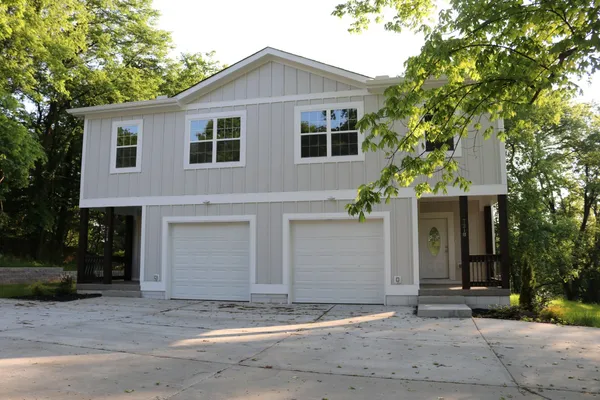 a view of a house with a yard and garage