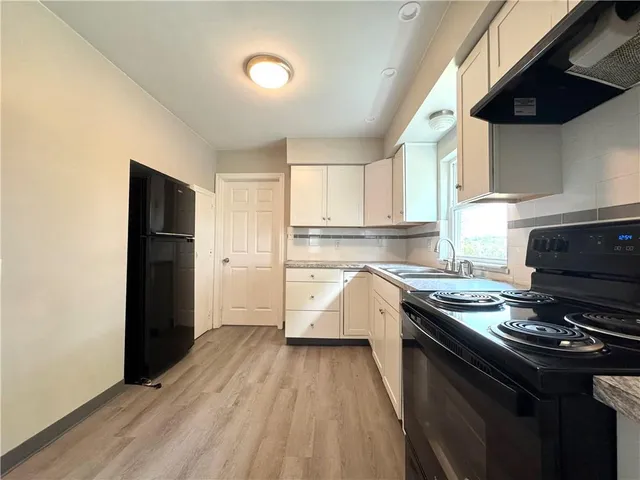 a kitchen with a stove and a refrigerator