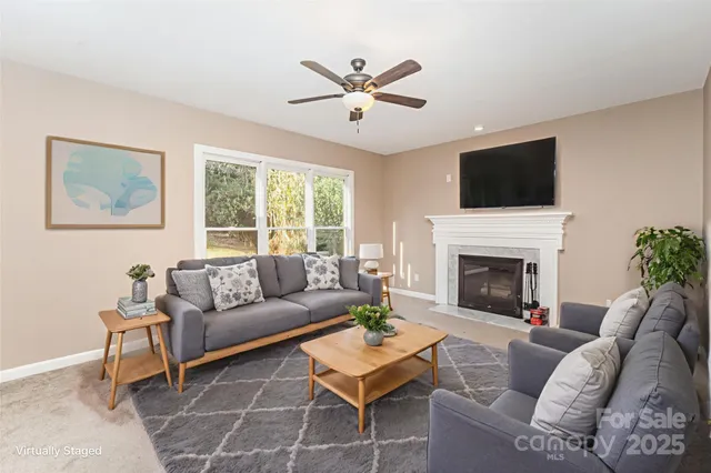 a living room with furniture a fireplace and a flat screen tv