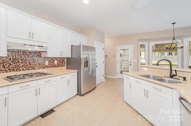 a kitchen with a sink stove and refrigerator