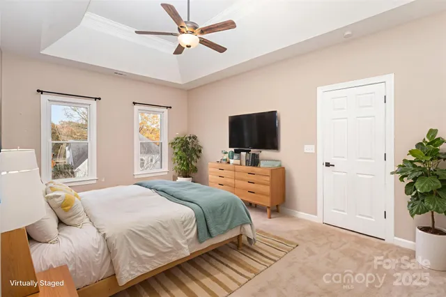 a bedroom with a bed flat screen tv and a window
