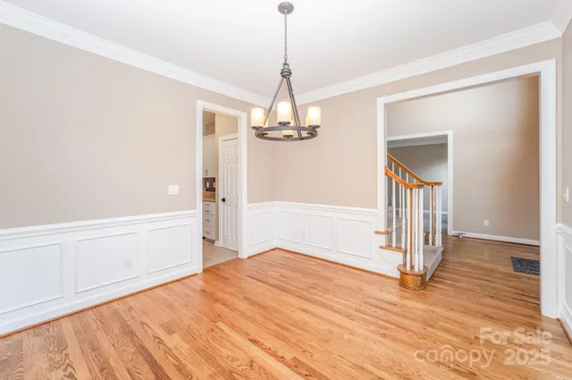 a very nice looking room with wooden floor and windows