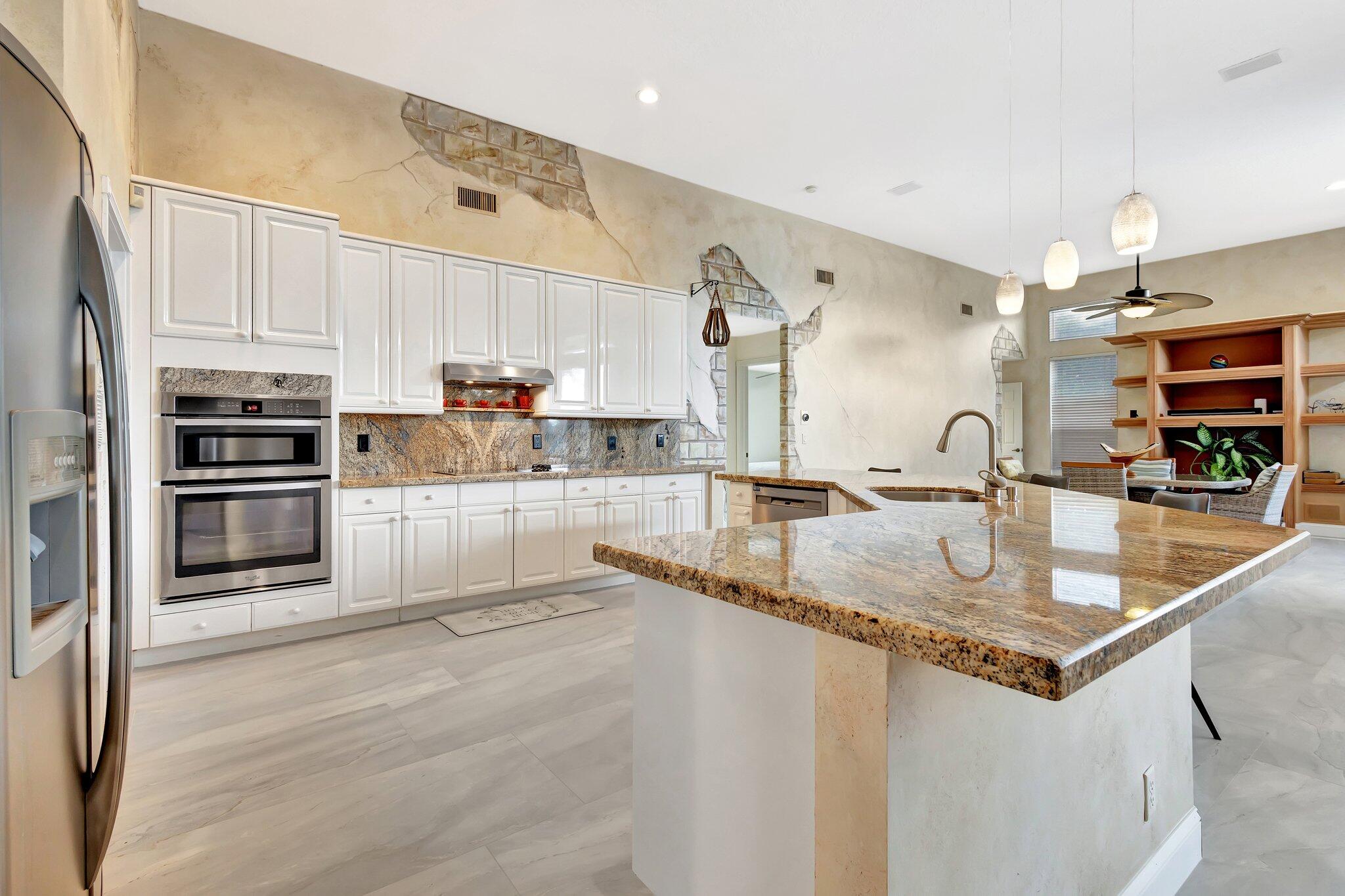 19236 Bay Leaf Court Boca Raton, FL 33498 - Photo 19 of 100 a kitchen with stainless steel appliances granite countertop a sink a stove and a refrigerator