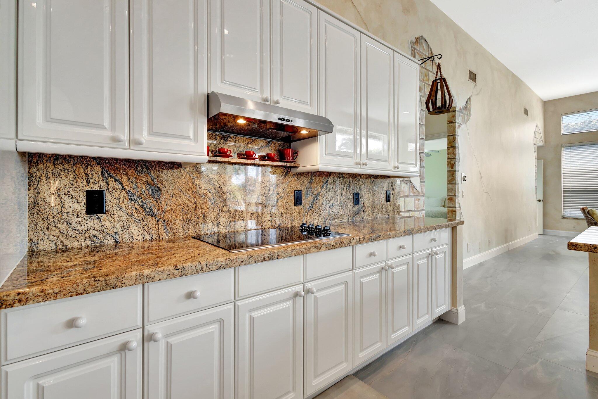 19236 Bay Leaf Court Boca Raton, FL 33498 - Photo 23 of 100 a kitchen with stainless steel appliances granite countertop white cabinets and a sink
