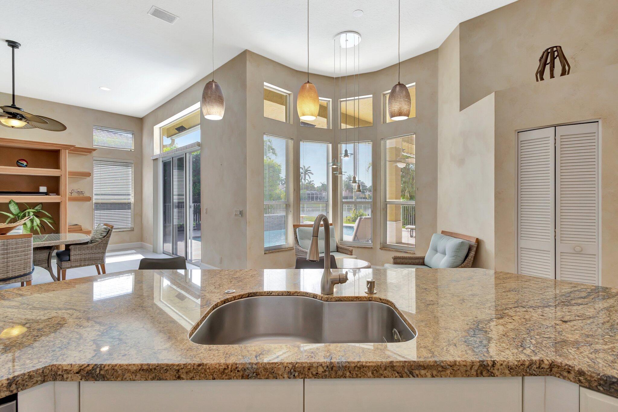 19236 Bay Leaf Court Boca Raton, FL 33498 - Photo 24 of 100 a kitchen with granite countertop a sink and a counter top space