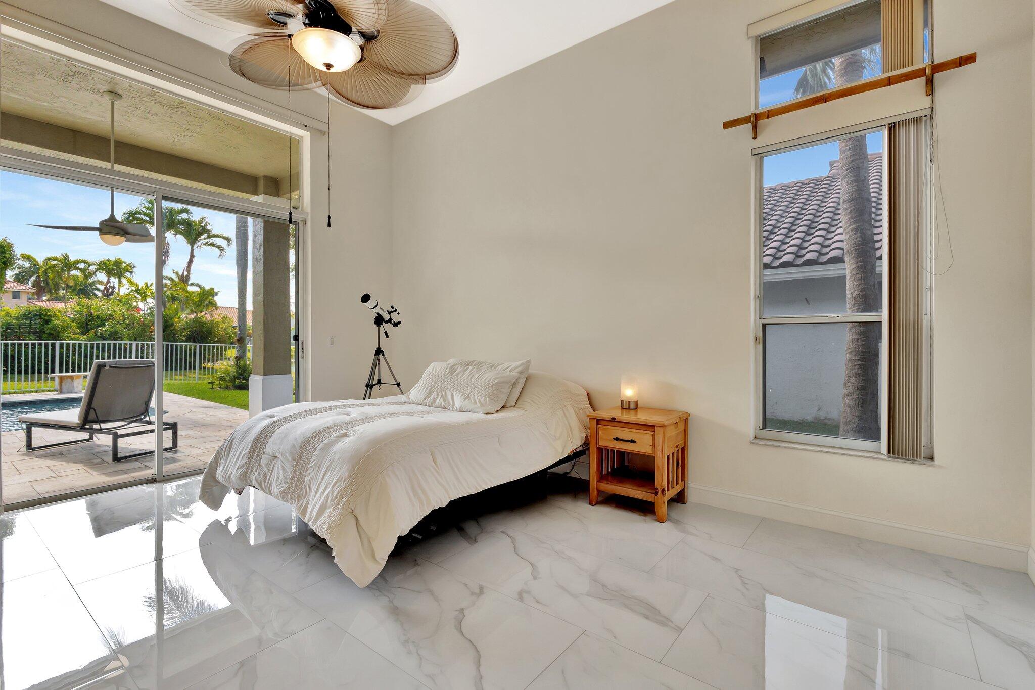 19236 Bay Leaf Court Boca Raton, FL 33498 - Photo 33 of 100 a bedroom with a bed and lamp