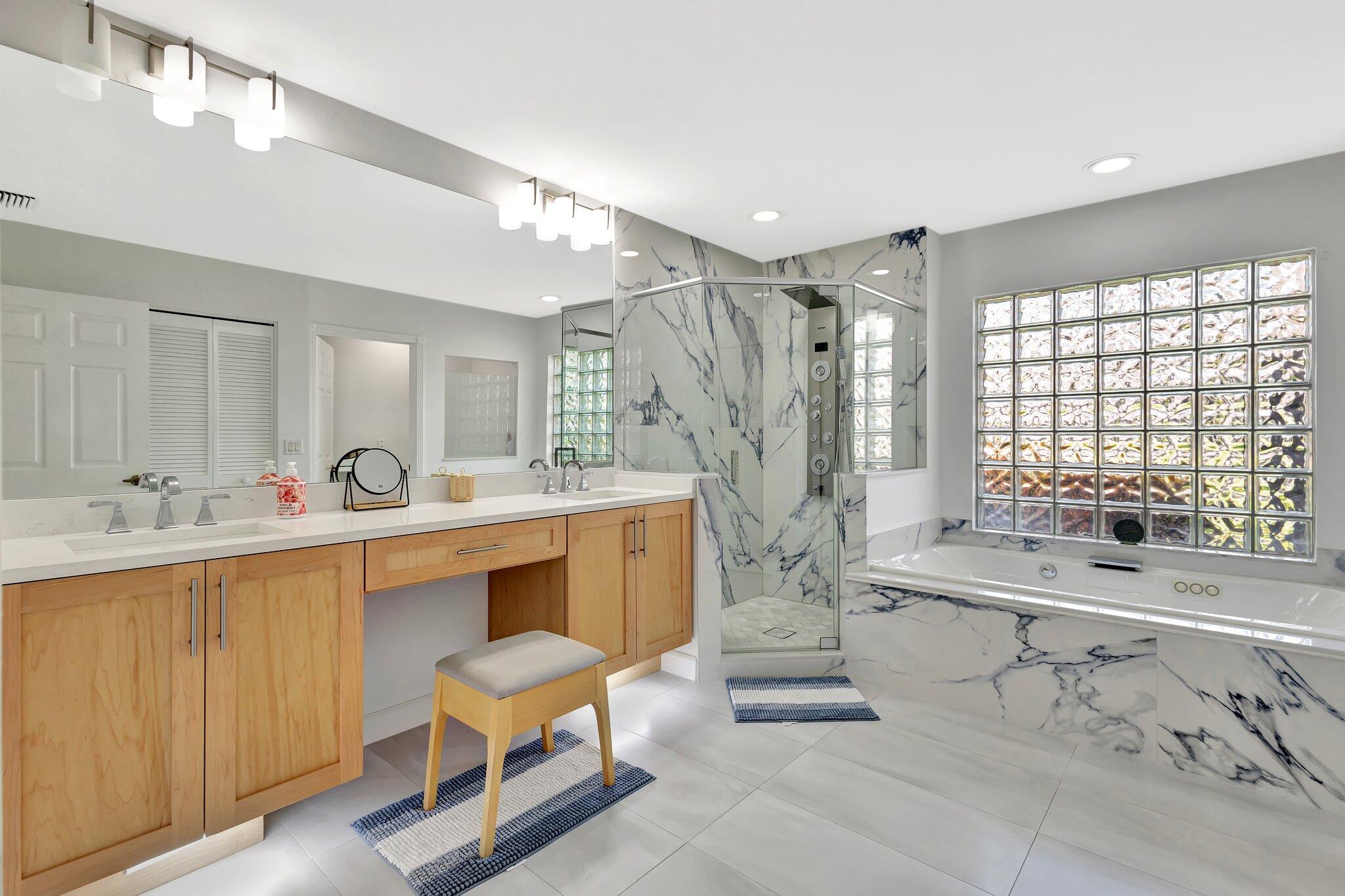 19236 Bay Leaf Court Boca Raton, FL 33498 - Photo 38 of 100 a bathroom with a double vanity sink mirror bathtub and shower