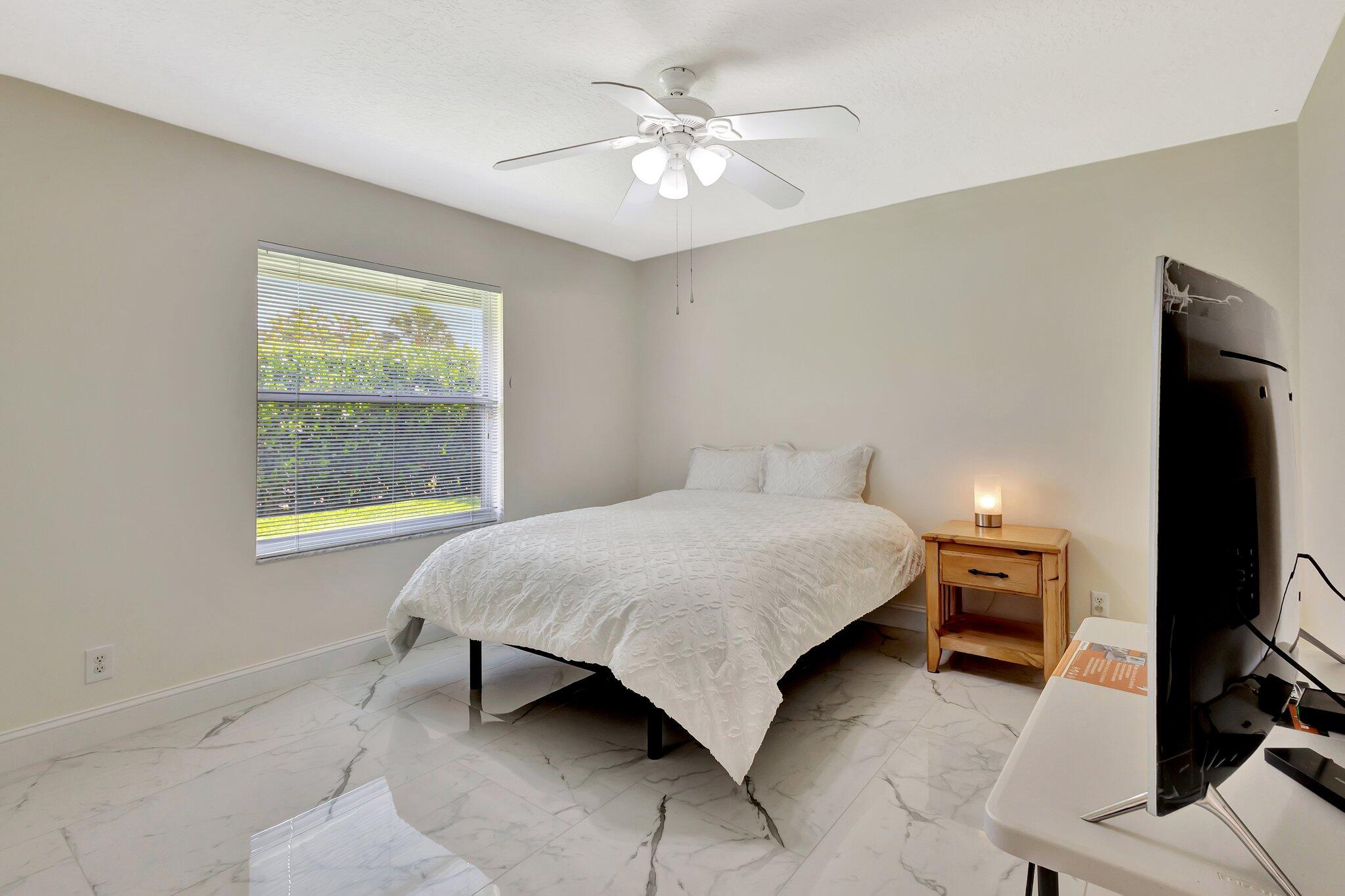 19236 Bay Leaf Court Boca Raton, FL 33498 - Photo 42 of 100 a bedroom with a bed and a tv