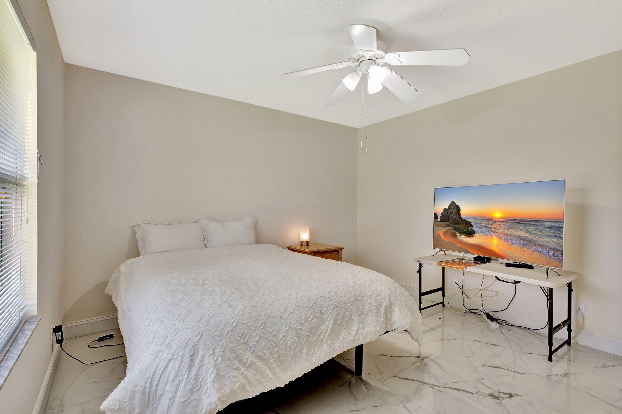 19236 Bay Leaf Court Boca Raton, FL 33498 - Photo 44 of 100 a bedroom with a bed a chair and potted plant on the dresser